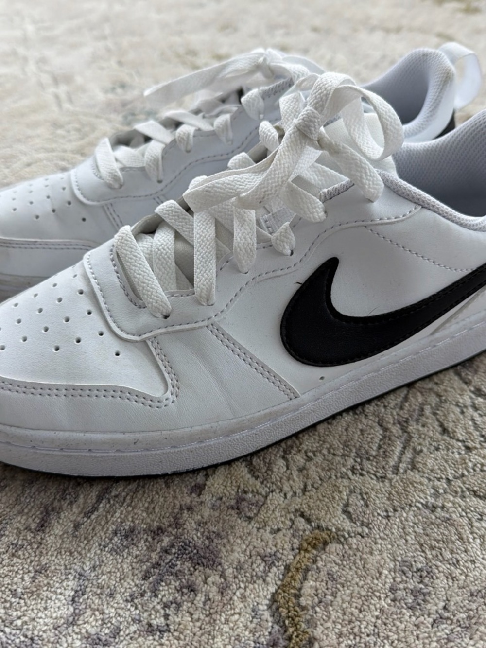 Nike Kid’s White Low-Top Sneaker with Black Swoosh